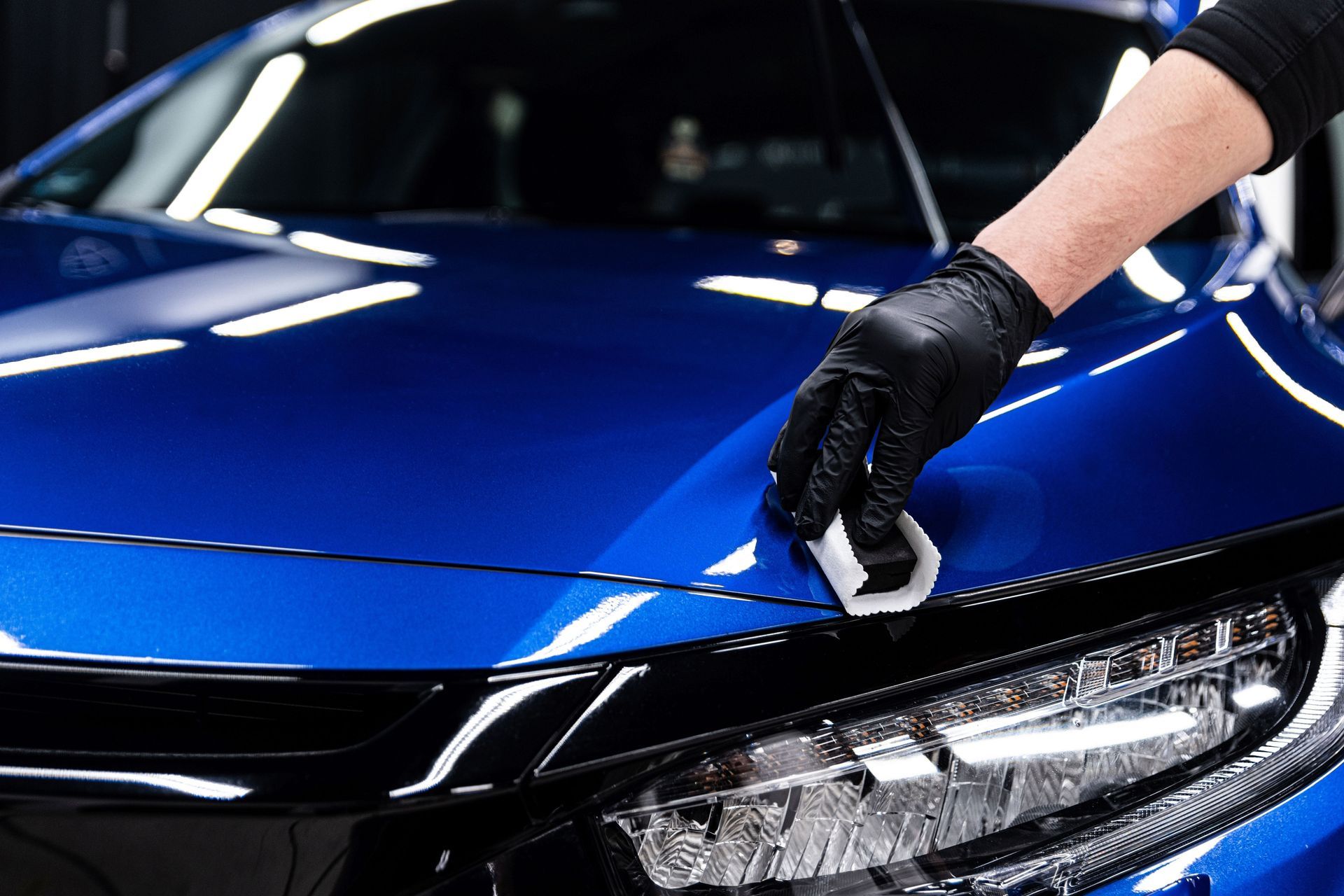 Ceramic coating applied to blue sports sedan hood
