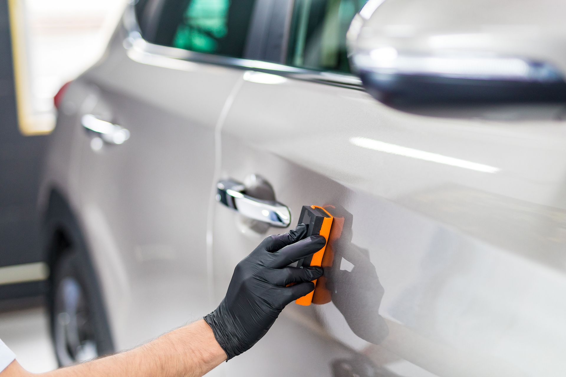 Coating applied to silver SUV door panel